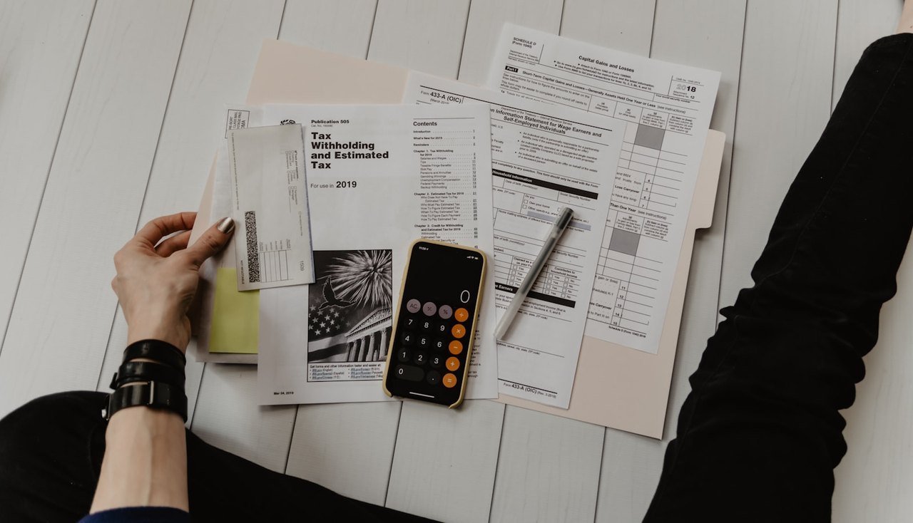 Planning documents and laptop for paid exam packages